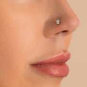 14k white gold oval-cut diamond flat back stud shown in nostril piercing, side profile on model