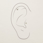Illustration of diamond butterfly stud ends placed in helix and lobe piercing positions on ear diagram