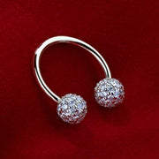 14K gold circular barbell with diamond pavé balls displayed on red velvet, overhead angle