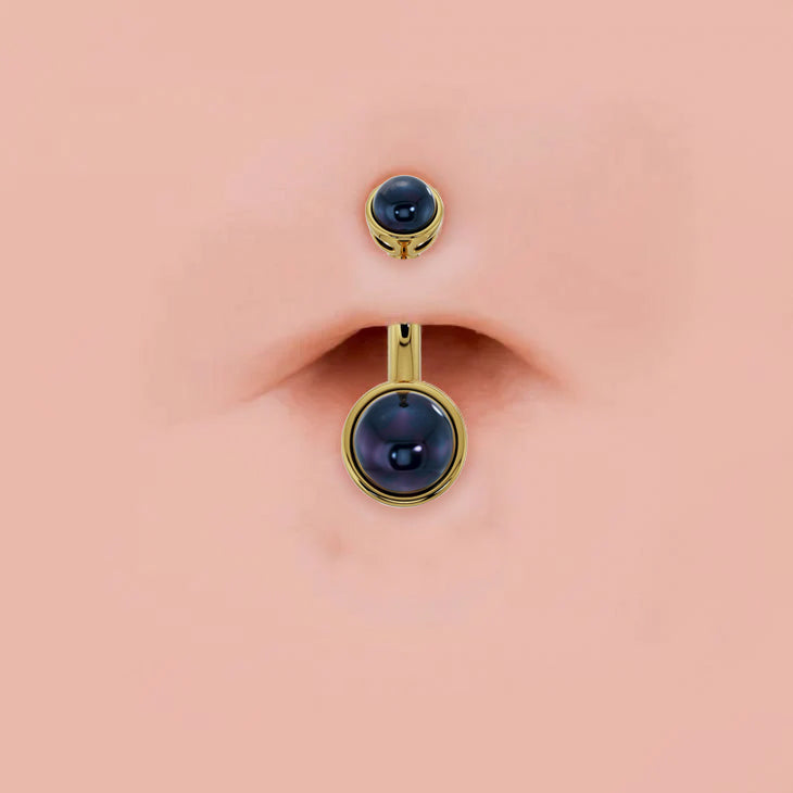 Black Akoya pearl bezel-set 14k gold belly ring shown in navel piercing for fit and scale reference