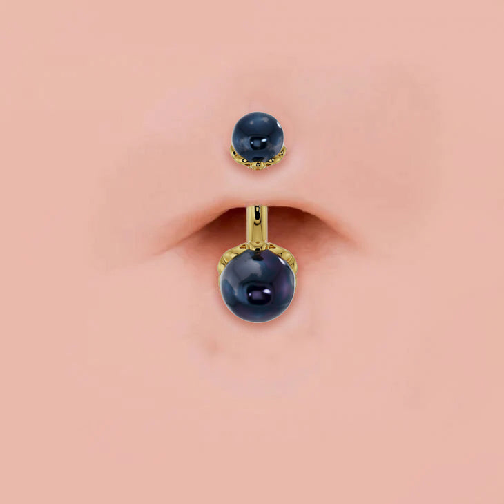 Black Akoya pearl 14k gold navel ring shown in pierced belly button, scroll setting detail visible