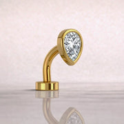 14k yellow gold teardrop floating belly ring with pear-cut CZ, angled studio view