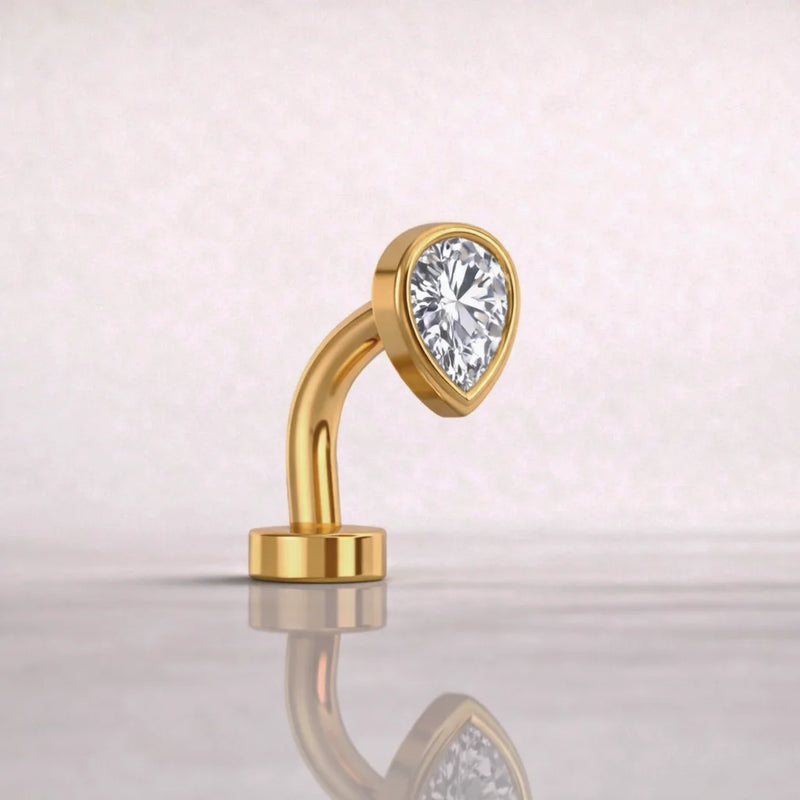 Side profile of 14k yellow gold petite teardrop floating belly ring with CZ, showing curved barbell shape