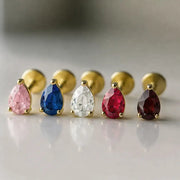 Five gold pear CZ flat back studs in pink, blue, clear, red, and garnet CZ stones, front view lineup