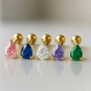 Five pear-cut gemstone flat back studs in 14k gold showing pink, blue, clear, purple, and green color options