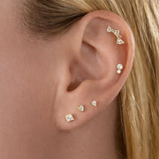 Diamond pear climber flat back stud worn in helix piercing, styled with multiple gold cartilage earrings