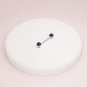 14K white gold black Akoya pearl nipple barbell displayed on white ceramic tray for scale