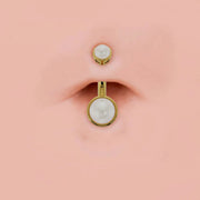 Bezel-set Akoya pearl 14k gold belly ring shown in navel piercing for fit reference