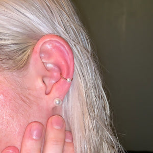 14K gold twisted pearl captive bead ring worn in a helix cartilage piercing on model