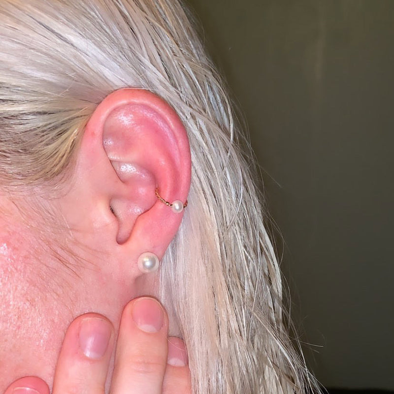 14K gold twisted pearl captive bead ring worn in a helix cartilage piercing on model