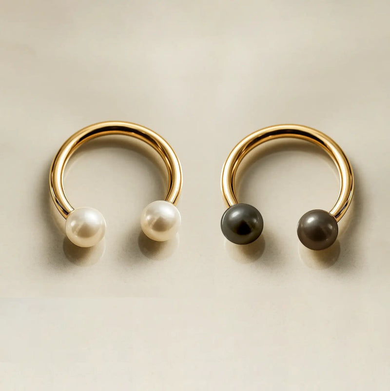 14K yellow gold pearl circular barbells side by side — white pearl and dark peacock pearl variations