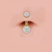14k yellow gold dual Akoya pearl belly ring shown in navel piercing for fit and scale reference