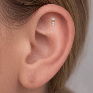 14k yellow gold prong diamond dangle cartilage flat back stud shown in helix piercing on model