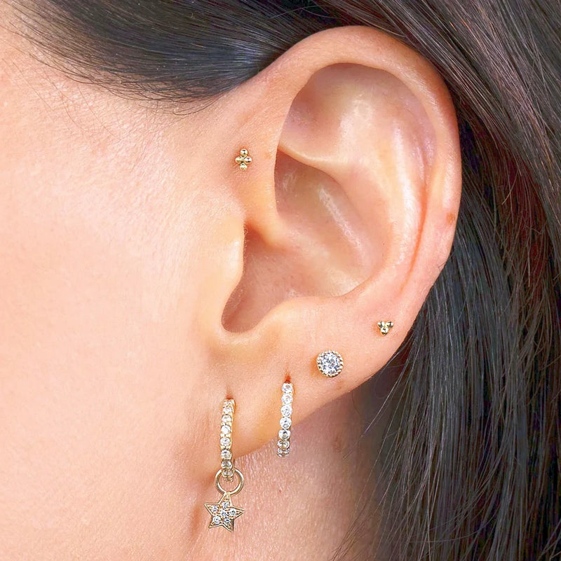 14K yellow gold 4-bead labret stud worn in helix piercing as part of a curated ear party
