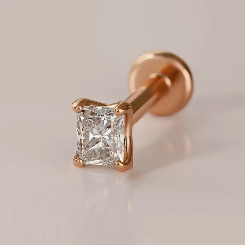 14k rose gold 2.3mm radiant-cut diamond flat back labret stud, angled view on warm neutral background