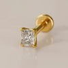 14k yellow gold 2.3mm radiant-cut diamond flat back labret stud, angled studio shot on warm background