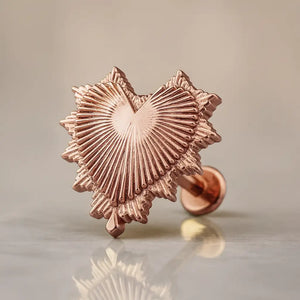 14k rose gold radiant heart flat back labret stud with sunburst ridged detail, angled studio shot