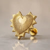 14k yellow gold radiant heart flat back labret stud with ridged sunburst texture, angled studio shot