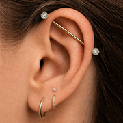 Model wearing the Reina Crown Diamond or Gemstone Industrial Barbell in 14k gold