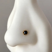 Reina rose cut black diamond nose stud in 14k gold, side view on a nose model