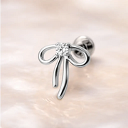 14k white gold ribbon bow diamond flat back stud with flat disc backing on marble surface