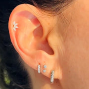Diamond bezel push pin ends worn in stacked lobe and cartilage piercings, white gold styling
