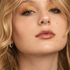 Slim platinum seam ring hoop worn as septum ring on model, front-facing close-up beauty shot