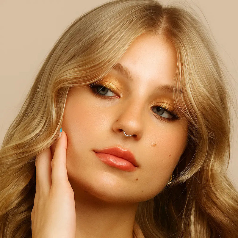 18K white gold plain clicker hoop as septum ring on model, three-quarter face view with hand raised