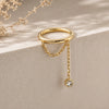 Diamond and yellow gold, a shanty seam ring lifestyle image dangling on a stone surface.