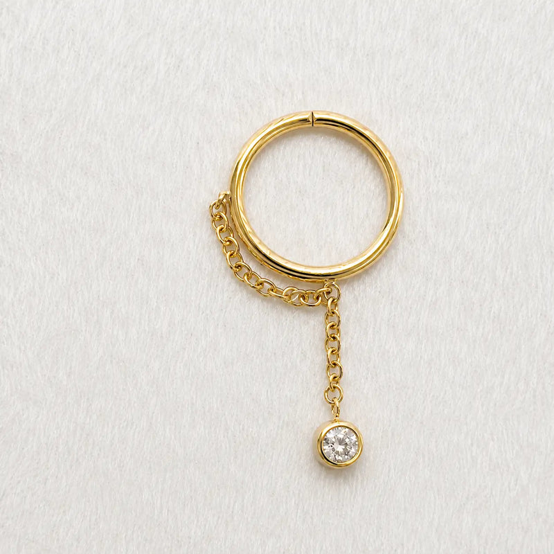 Yellow gold shanty seam ring with a diamond on a white surface lifestyle image.