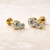 14k yellow gold diamond bubble flat back studs, small and large sizes shown side by side on marble surface