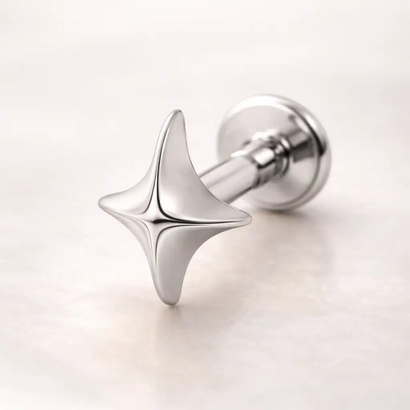 14k white gold sparkle flat back stud with four-point star charm, angled view on light background