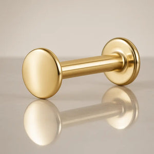 14K yellow gold polished disc flat back labret stud, angled view showing disc end and flat backing
