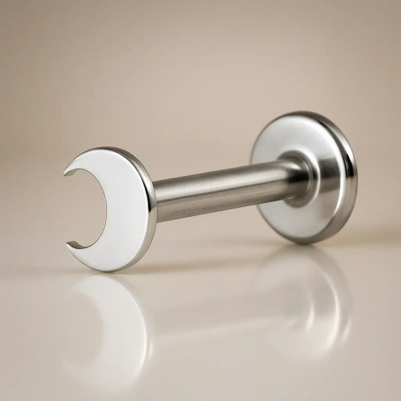 14k white gold crescent moon flat back labret stud, angled side view on neutral background