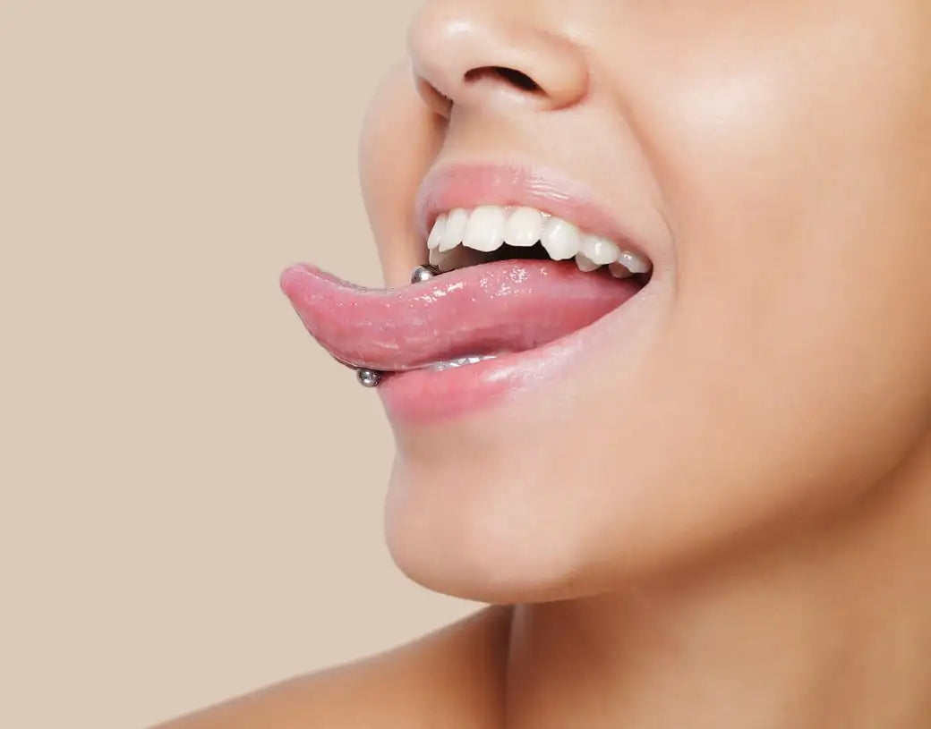 Close-up of a person's lips and her tongue ring.