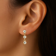 14K yellow gold trinity drop CZ flat-back stud shown in pierced earlobe, side profile for fit reference