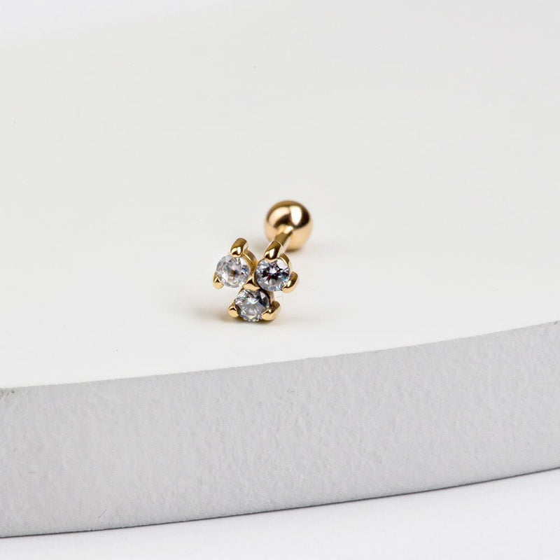 14k yellow gold triple diamond cluster stud with ball back, displayed on white surface edge