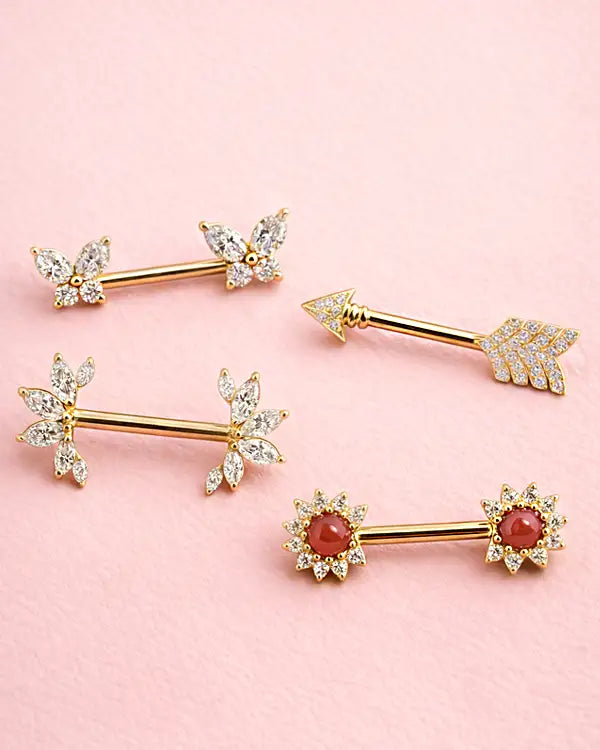 Fancy nipple barbells on pink background
