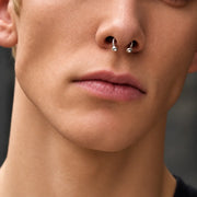 14k white gold circular barbell worn as a septum piercing, shown close up on a model
