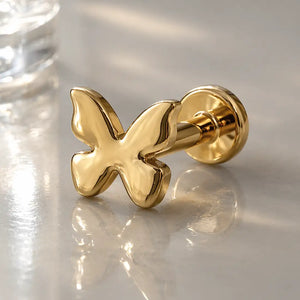 14k yellow gold butterfly flat back labret stud showing polished wings and flat disc backing, angled view