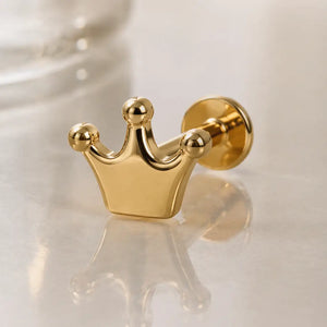 14k yellow gold crown flat back labret stud on marble surface, angled view showing flat disc backing