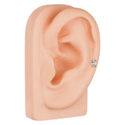 14k yellow gold pear diamond stud shown in lobe on silicone ear model, angled side view for fit reference