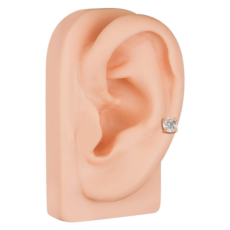 14k rose gold diamond cartilage stud shown in lobe piercing on ear model, angled side view