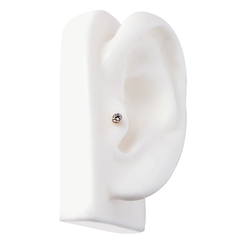 Yellow gold diamond bezel cartilage stud on ear model showing tragus placement and fit