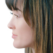 1.5mm tiny diamond nose stud shown in pierced nostril, side profile view on model