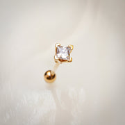 14k yellow gold princess cut diamond cartilage stud on soft white background, angled view