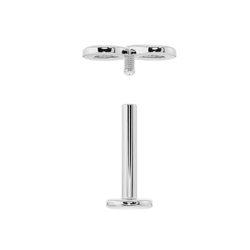 Disassembled flat back labret showing internally threaded post and separate infinity symbol end piece