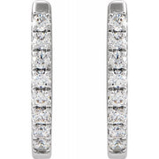 White gold diamond huggie hoops shown flat front view, highlighting full row of prong-set round diamonds