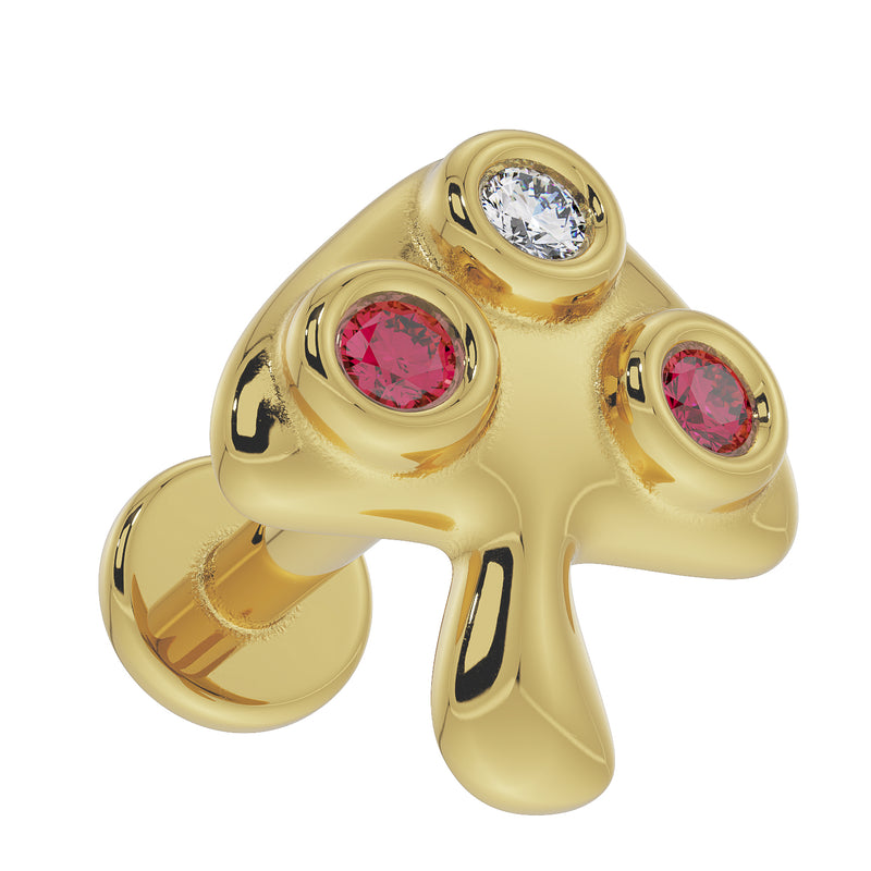 14K yellow gold mushroom labret top viewed from above-angle, showing bezel-set diamond and ruby detail