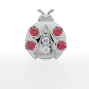 14K white gold ladybug flat back stud, straight-on front view showing four garnet spots and two center diamonds